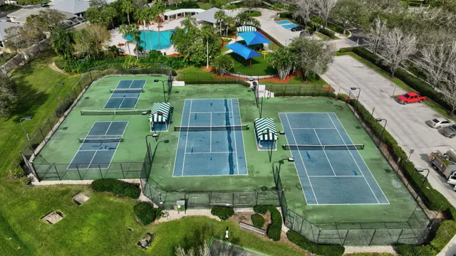 an aerial view of residential houses with outdoor space and lake view