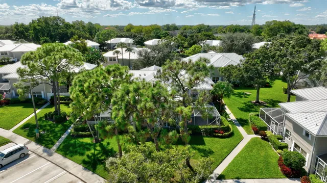 an aerial view of a house with outdoor space and lake view