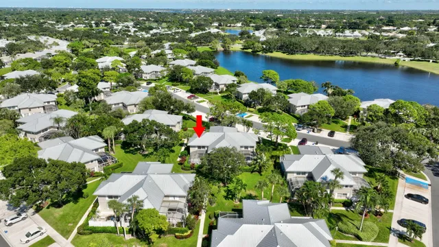 an aerial view of a house with a yard lake view and mountain view