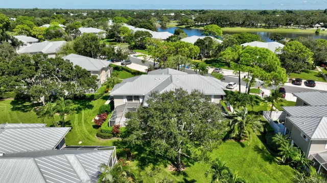 a aerial view of a house with a yard and lake view