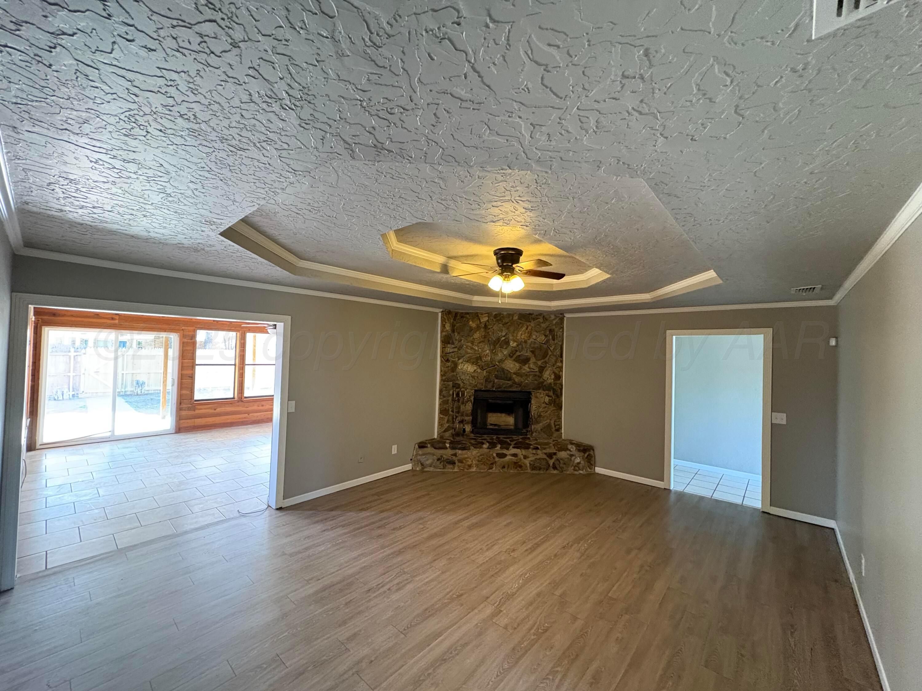 6210 Rutgers Street Amarillo, TX 79109 - Photo 2 of 13 wooden floor in an empty room with a window