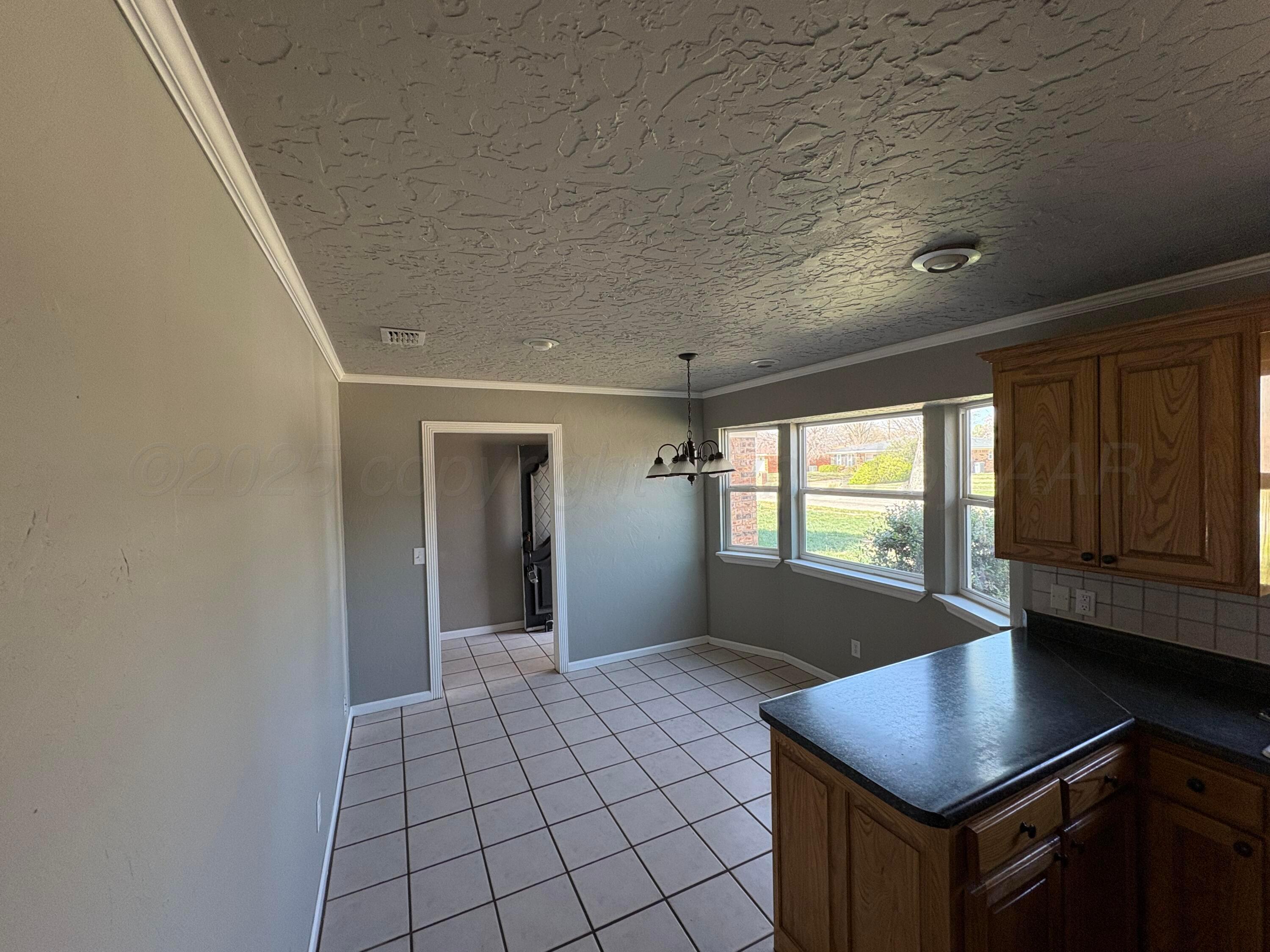 6210 Rutgers Street Amarillo, TX 79109 - Photo 5 of 13 a view of an empty room with window and cabinet