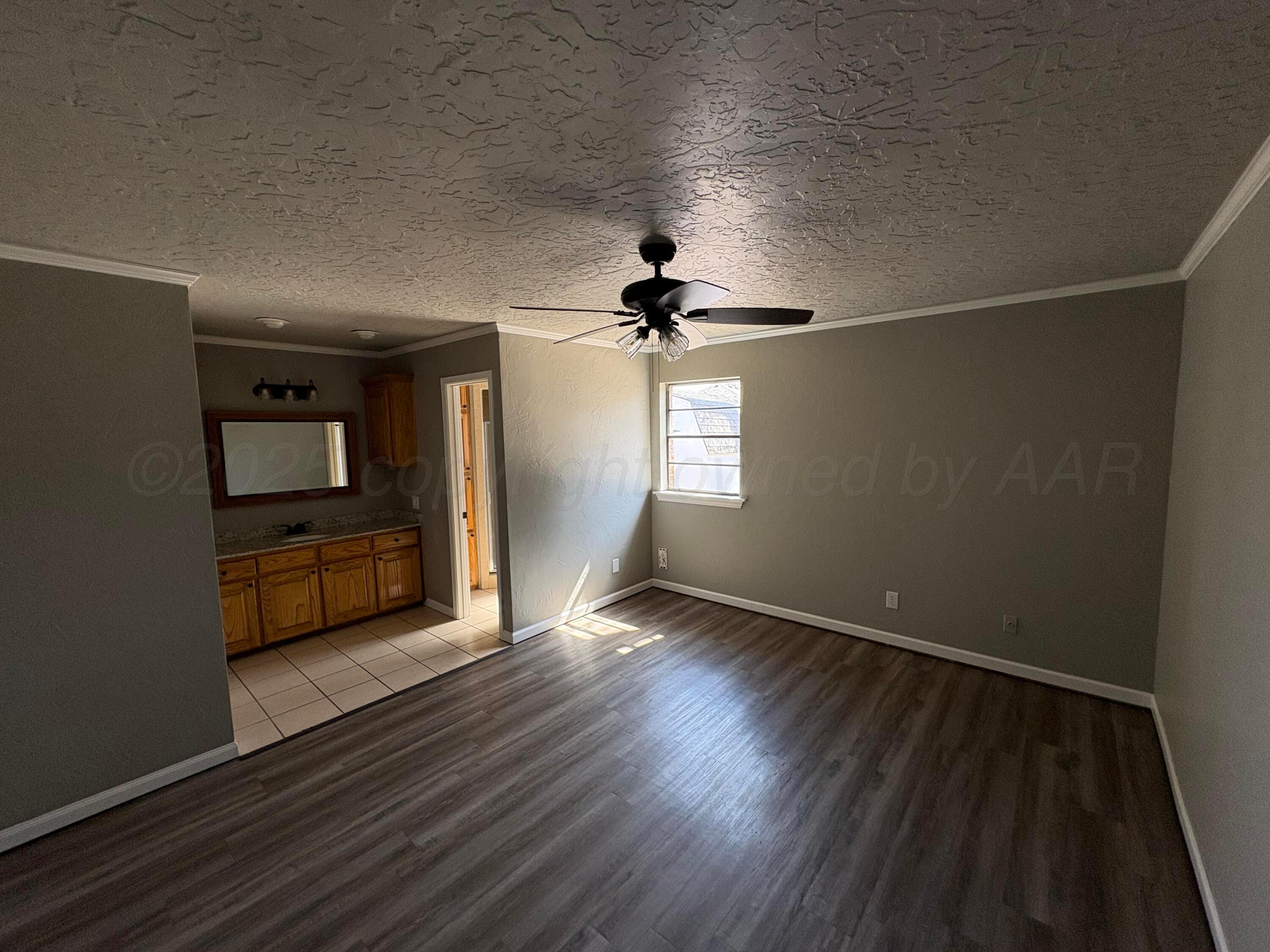 6210 Rutgers Street Amarillo, TX 79109 - Photo 6 of 13 wooden floor in an empty room with a window