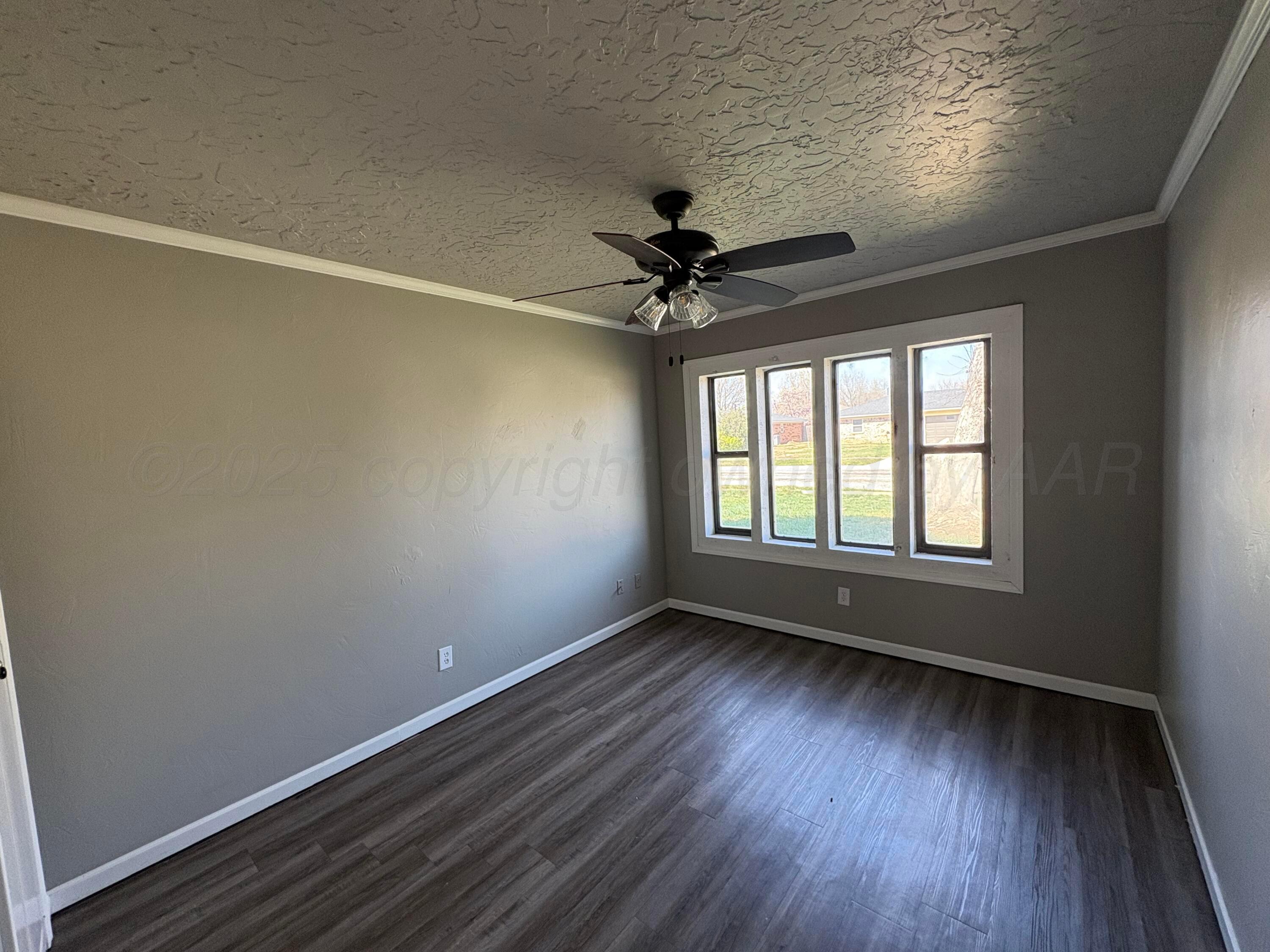 6210 Rutgers Street Amarillo, TX 79109 - Photo 9 of 13 wooden floor in an empty room with a window