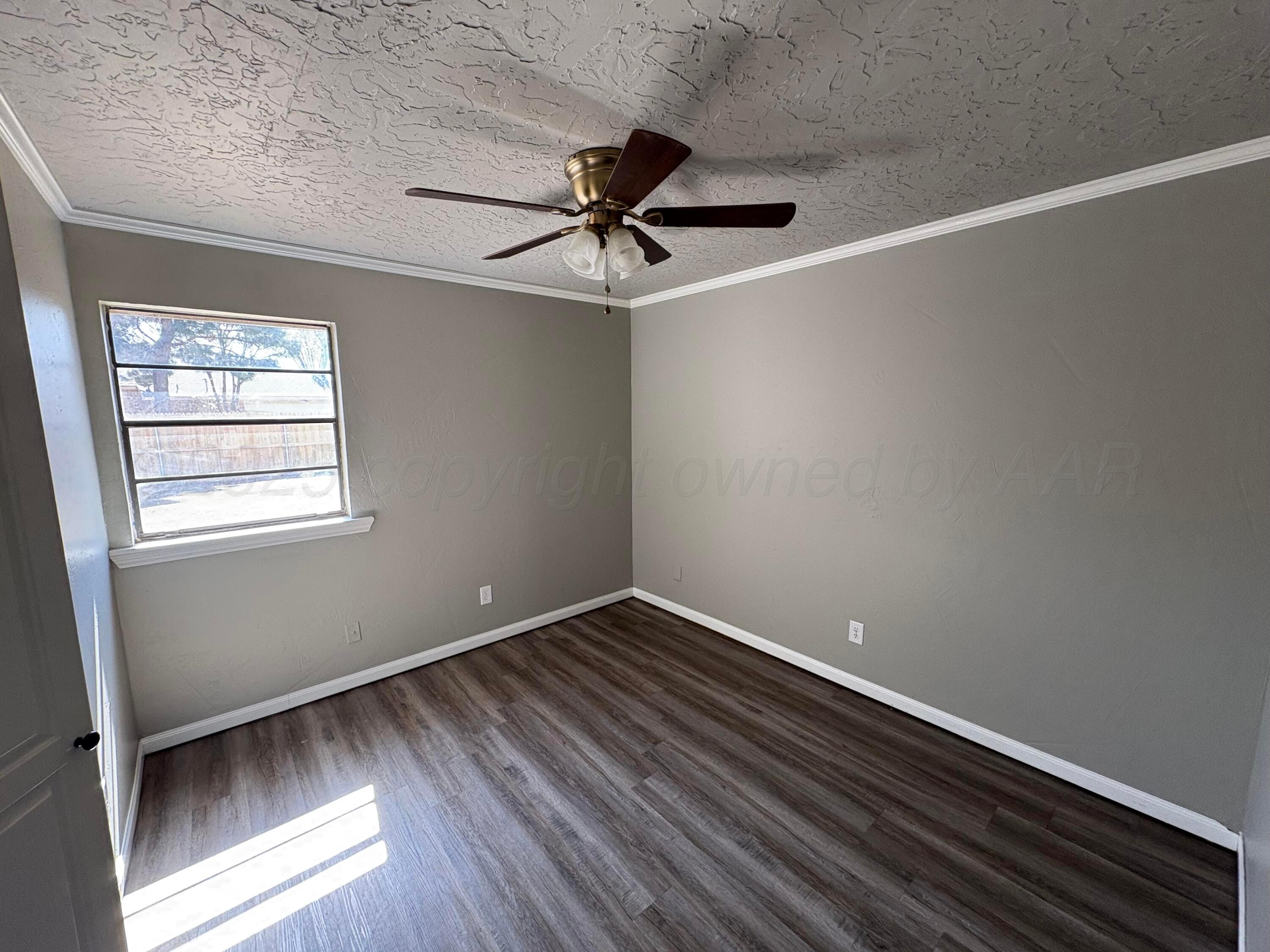 6210 Rutgers Street Amarillo, TX 79109 - Photo 10 of 13 a view of room with window and wooden floor