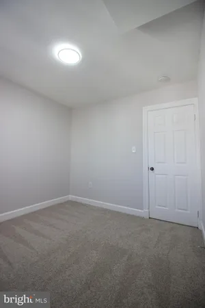 a spacious bathroom with a toilet sink and mirror