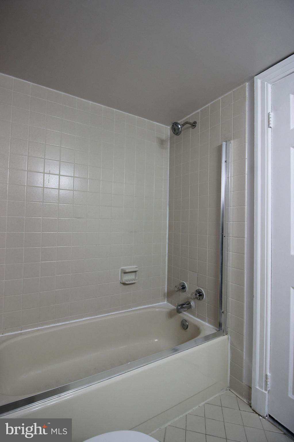 1218 Eton Court Northwest Washington, DC 20007 - Photo 13 of 22 a bathroom with a bathtub a toilet and a shower