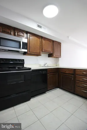 a kitchen with stainless steel appliances granite countertop a stove and a sink