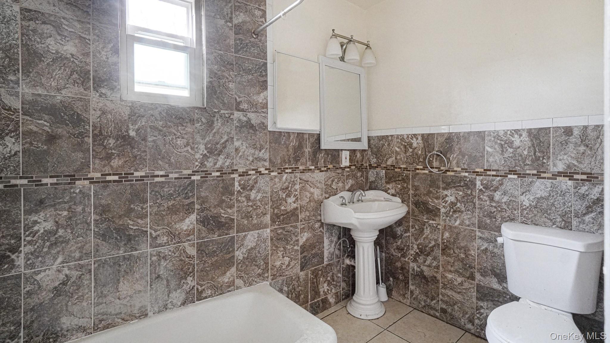 111 South Fulton Avenue Mount Vernon, NY 10550 - Photo 13 of 19 Full bathroom with tile patterned flooring and tile walls
