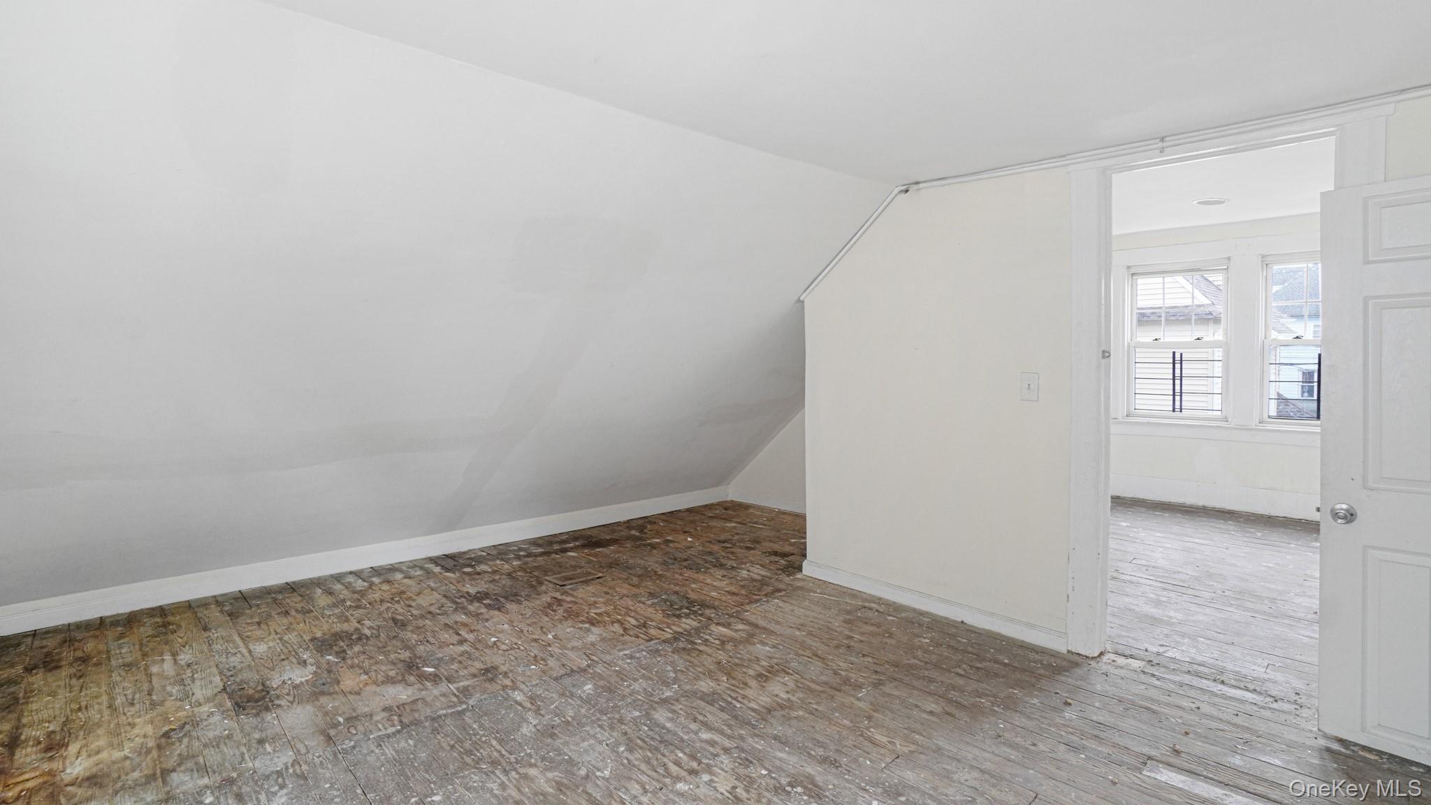 111 South Fulton Avenue Mount Vernon, NY 10550 - Photo 14 of 19 Additional living space with wood-type flooring and lofted ceiling
