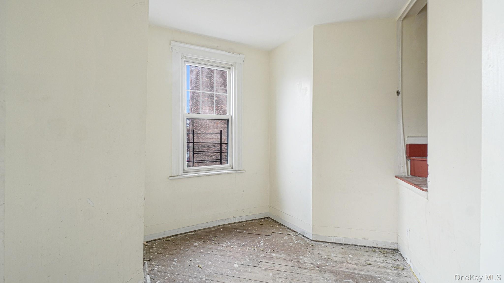 111 South Fulton Avenue Mount Vernon, NY 10550 - Photo 10 of 19 Unfurnished room featuring baseboards and hardwood / wood-style flooring