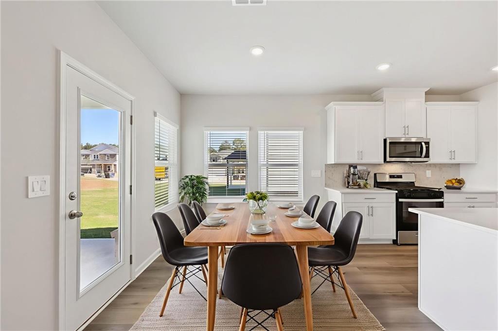 1499 High Fls Lane Grayson, GA 30017 - Photo 12 of 37 a view of a dining room with furniture window and wooden floor