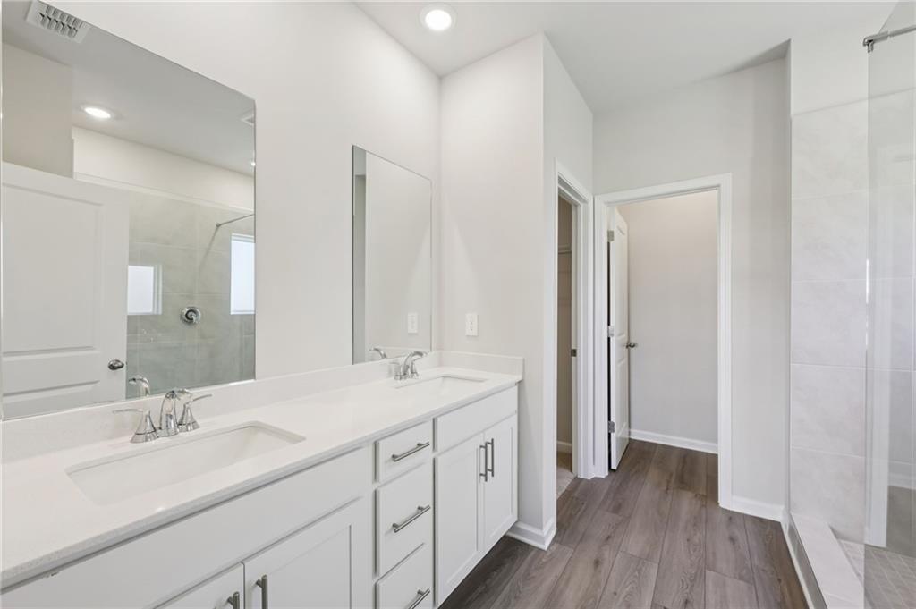 1499 High Fls Lane Grayson, GA 30017 - Photo 25 of 37 a bathroom with a double vanity sink and mirror