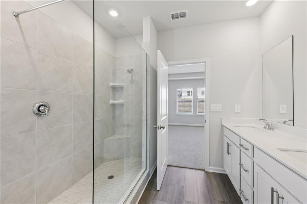 1499 High Fls Lane Grayson, GA 30017 - Photo 26 of 37 a spacious bathroom with a shower sink and mirror