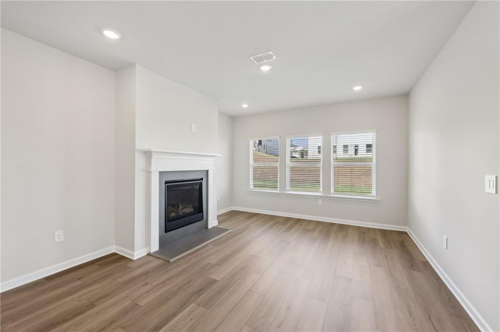 1499 High Fls Lane Grayson, GA 30017 - Photo 5 of 37 wooden floor in an empty room with a window