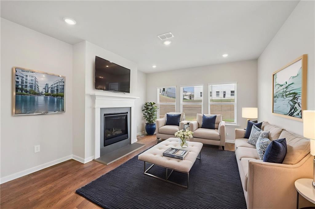 1499 High Fls Lane Grayson, GA 30017 - Photo 6 of 37 a living room with furniture fireplace and flat screen tv