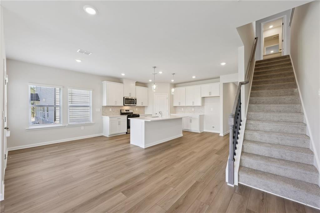 1499 High Fls Lane Grayson, GA 30017 - Photo 8 of 37 a view of kitchen with wooden floor and electronic appliances