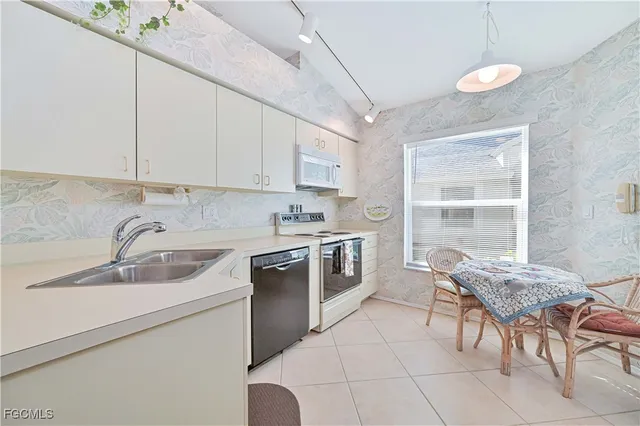 a kitchen with a sink cabinets and window