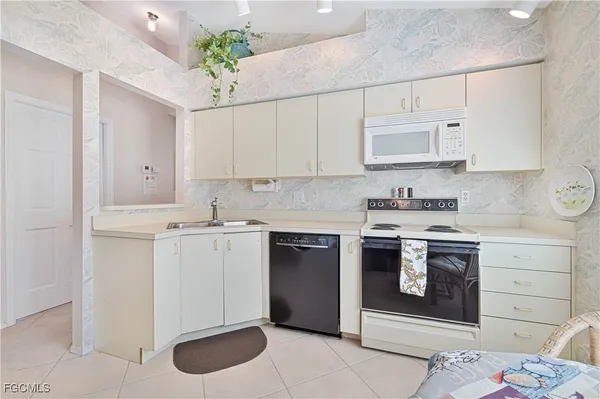 a kitchen with a stove sink and cabinets