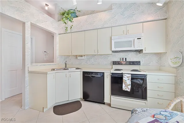 a kitchen with a stove sink and cabinets