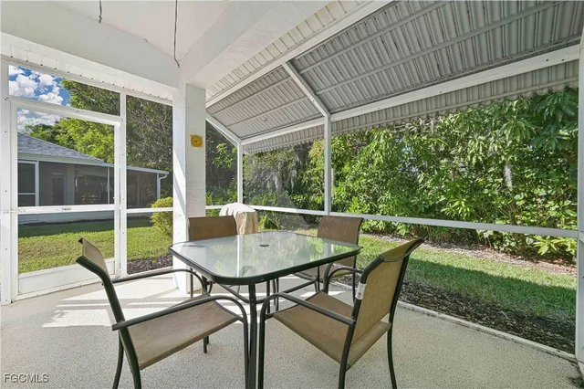a view of a patio with table and chairs with wooden floor and fence
