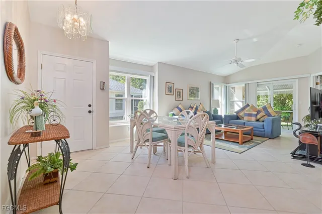 a dining room with furniture a chandelier and a rug