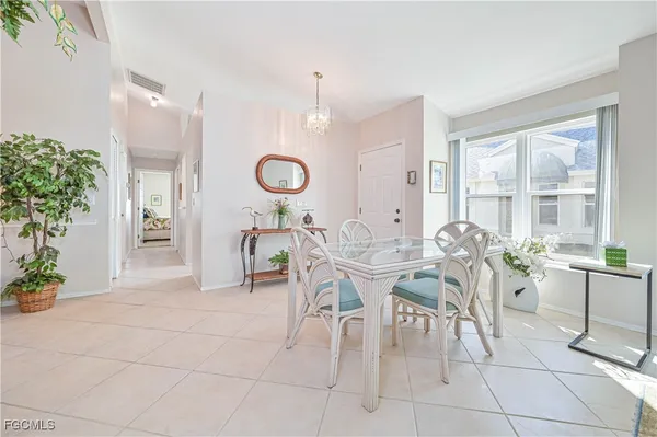 a view of a dining room and livingroom with furniture wooden floor and a rug
