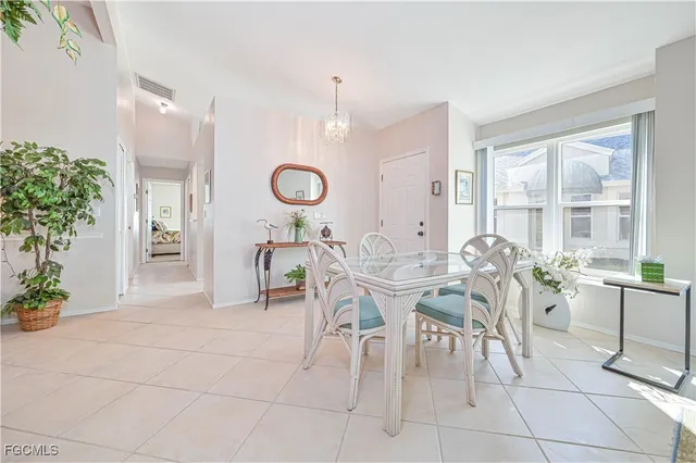 a view of a dining room and livingroom with furniture wooden floor and a rug