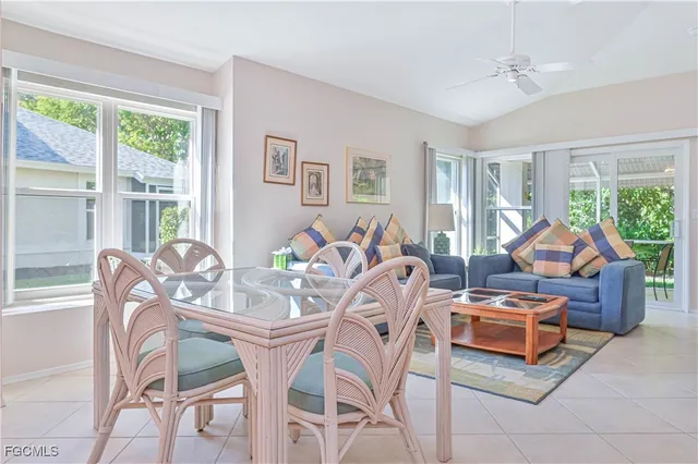 a living room with furniture and a floor to ceiling window