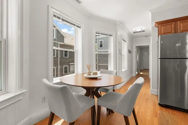 a dining room with furniture and window