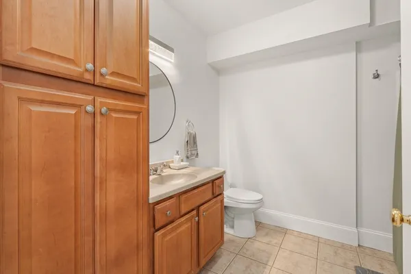 a bathroom with a granite countertop sink a toilet and a shower