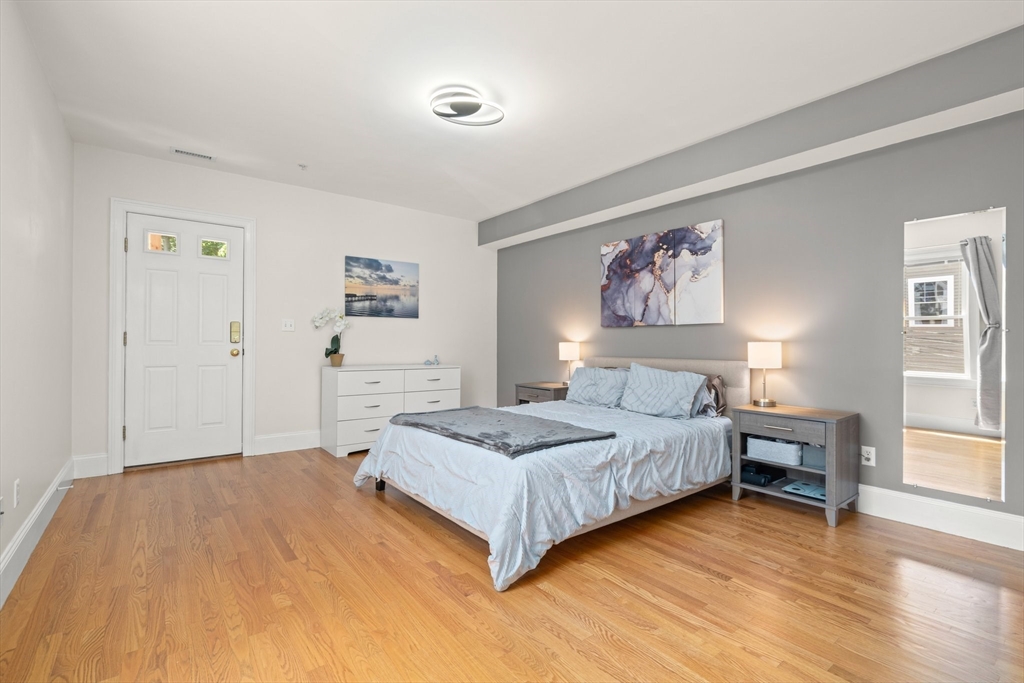 17 Robbins Street, Unit 22 Waltham, MA 02453 - Photo 15 of 27 a spacious bedroom with a bed and a cabinets