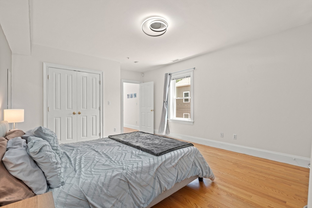 17 Robbins Street, Unit 22 Waltham, MA 02453 - Photo 17 of 27 a bedroom with a bed and a window