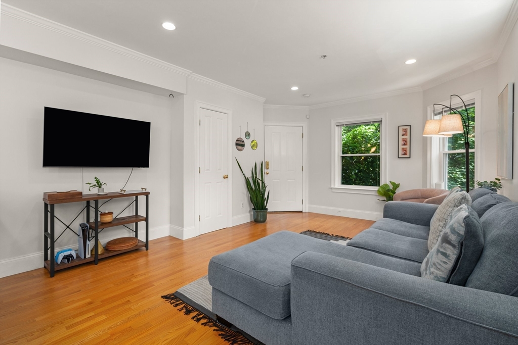 17 Robbins Street, Unit 22 Waltham, MA 02453 - Photo 2 of 27 a living room with furniture and a flat screen tv