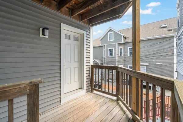 a view of a balcony with wooden floor