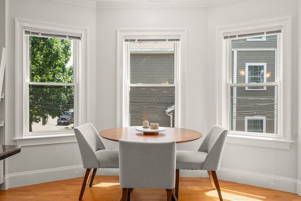 17 Robbins Street, Unit 22 Waltham, MA 02453 - Photo 9 of 27 a dining room with furniture window wooden floor