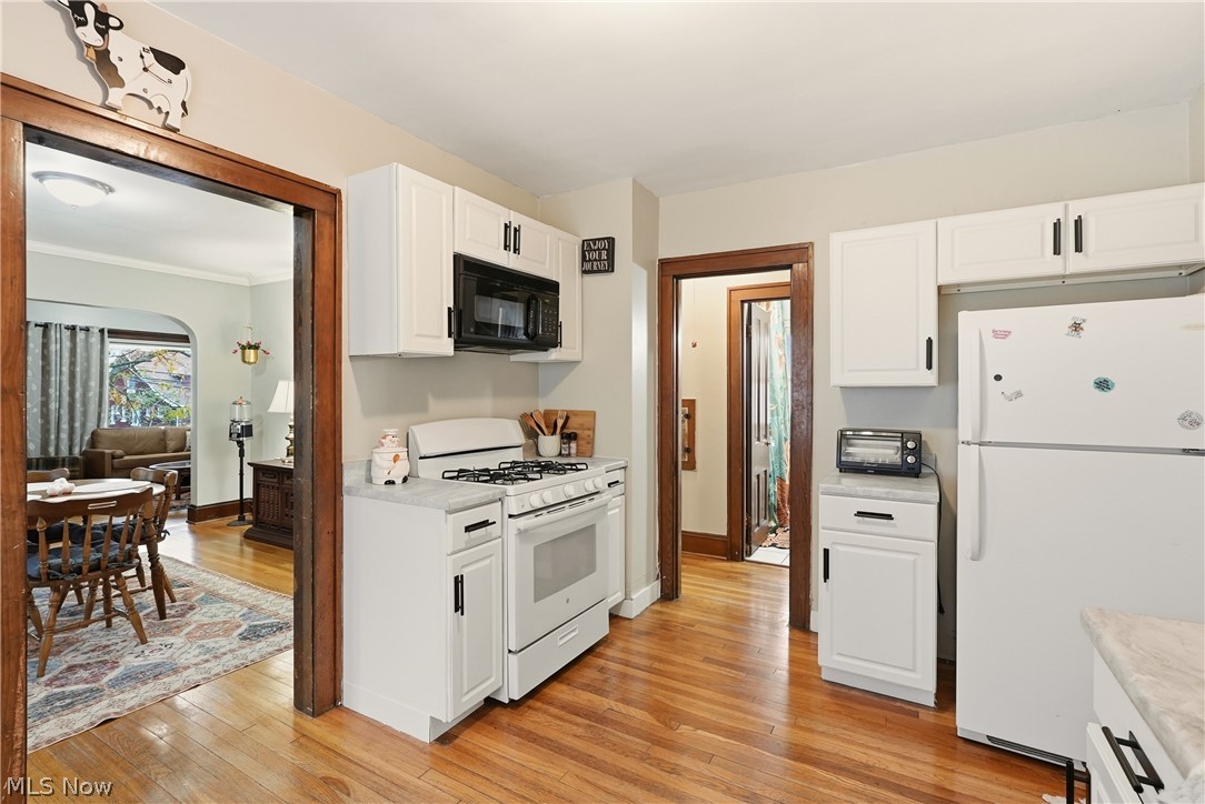 3579 Bosworth Road Cleveland, OH 44111 - Photo 16 of 39 Kitchen featuring white cabinetry, wood-finish flooring, and light-toned countertops
