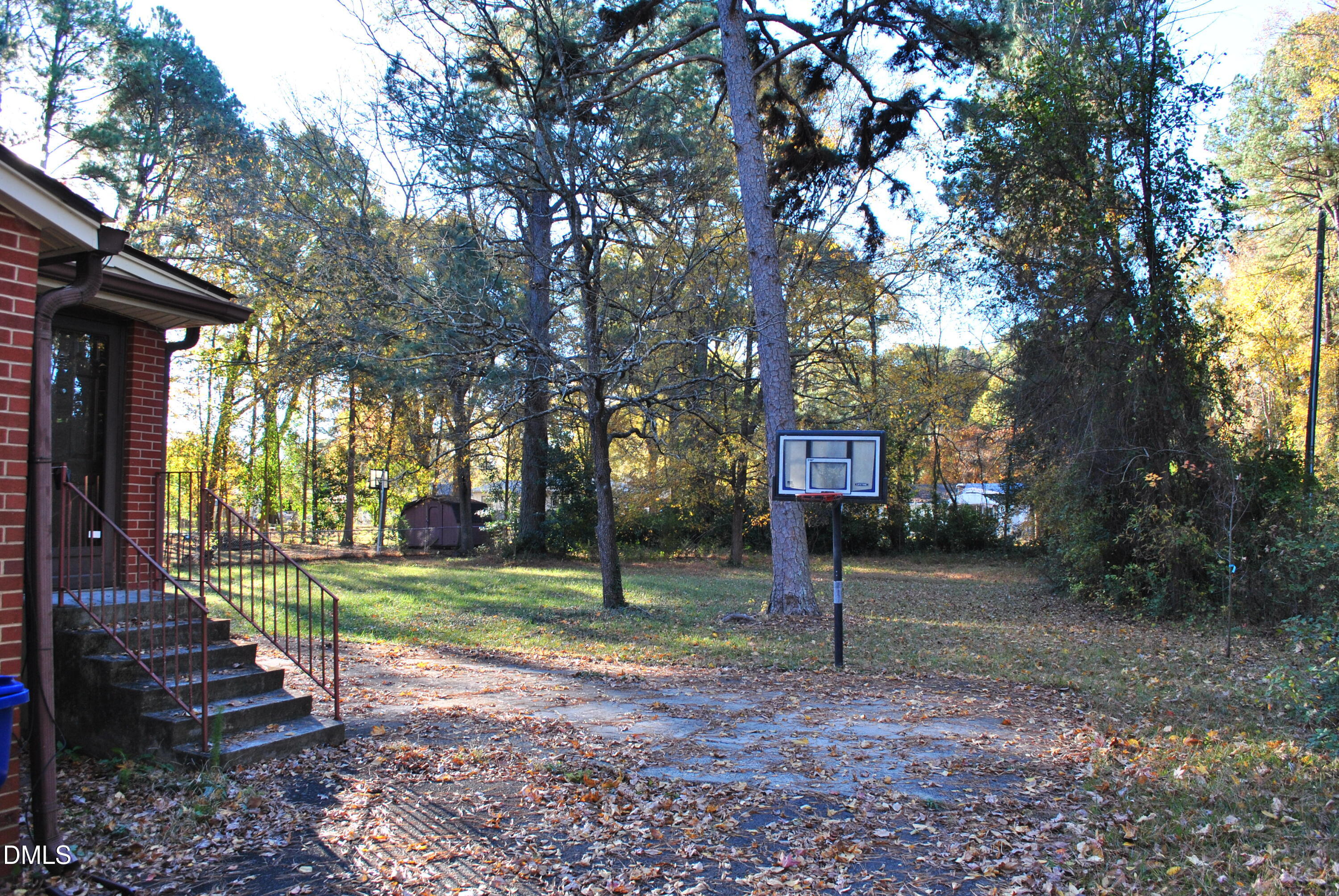 717 Crosby Road Durham, NC 27704 - Photo 4 of 15 a view of a park that has a tree on the side of it with wooden fence