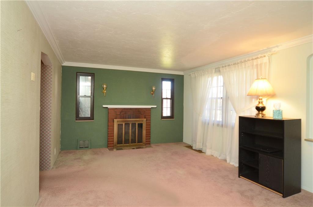 517 Old Farm Road Pittsburgh, PA 15234 - Photo 3 of 24 First greeted by a cozy Living room boasting a wood burning fireplace with brick surround & crown moulding.