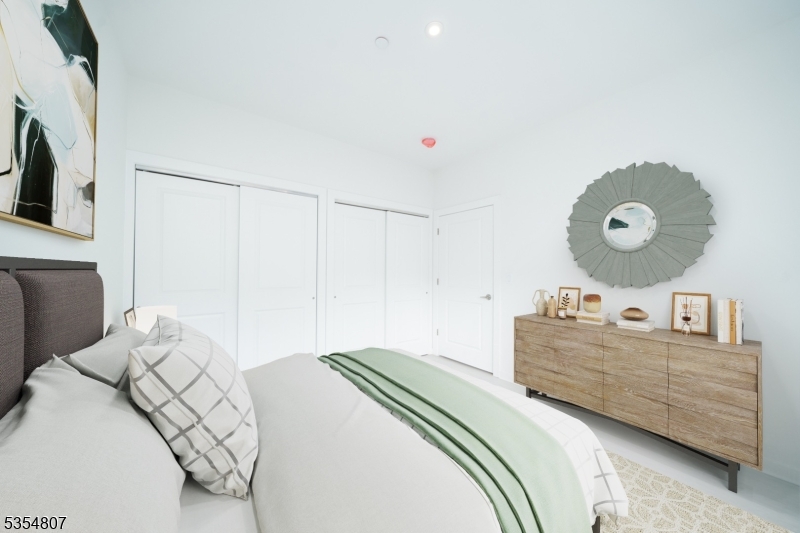 12 River Road, Unit 205 Fair Lawn, NJ 07410 - Photo 5 of 9 a bedroom with a bed and cabinets