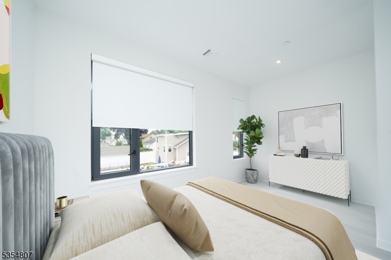 12 River Road, Unit 205 Fair Lawn, NJ 07410 - Photo 6 of 9 a bedroom with a large bed and a large window