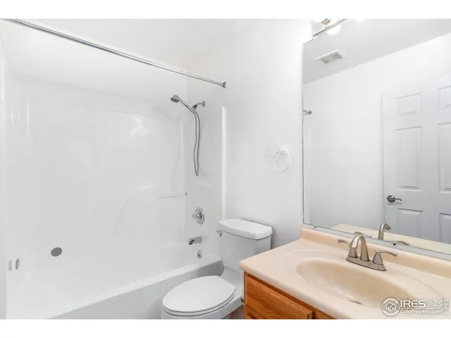 a bathroom with a sink toilet a shower and a mirror