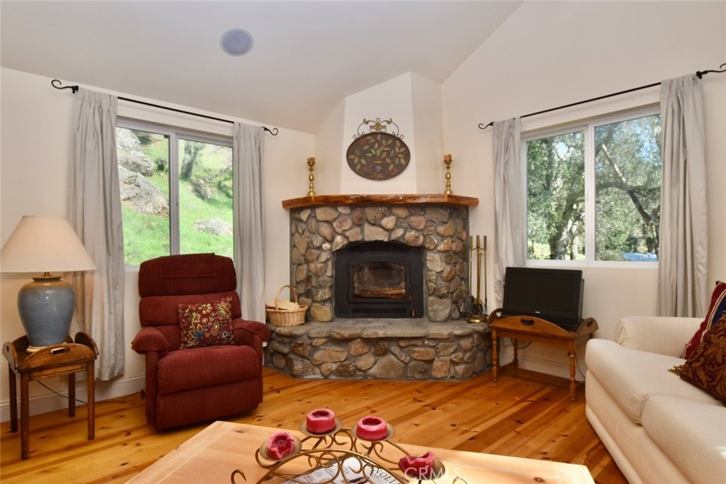 76450 Deer Pass Road Bradley, CA 93426 - Photo 7 of 50 a living room with furniture a window and a fireplace