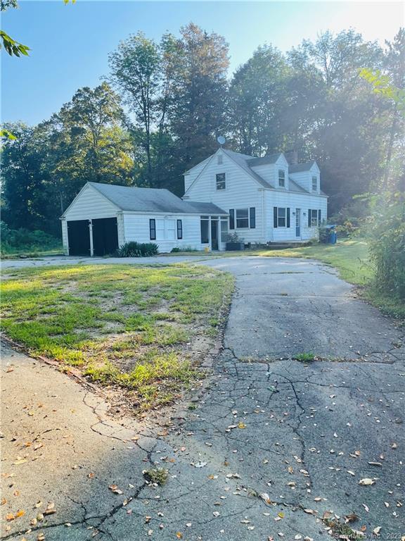 90 Wauregan Road Brooklyn, CT 06234 - Photo 1 of 1 a front view of house with yard and trees in the background