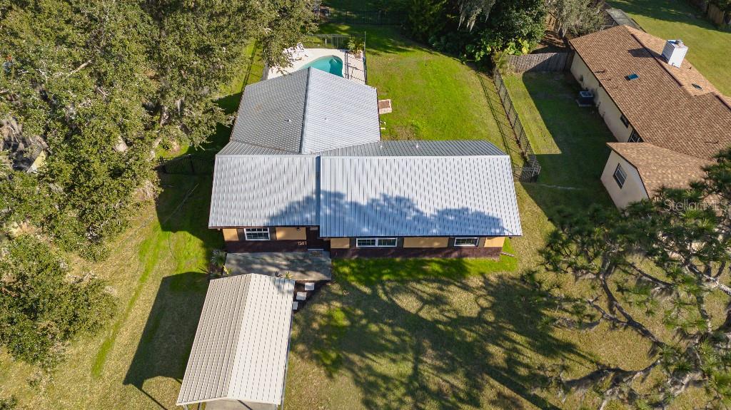 1507 Hontoon Road DeLand, FL 32720 - Photo 1 of 1 an aerial view of a house with swimming pool and large trees