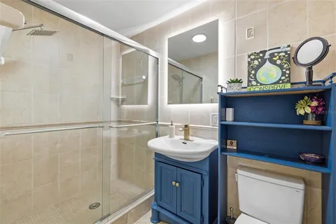 a bathroom with a sink a mirror and a shower