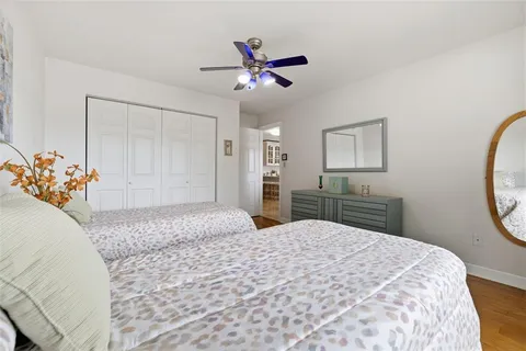 a bedroom with a large bed and a chandelier