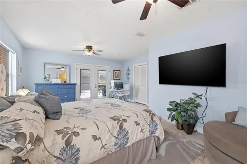 a bedroom with a bed and a flat screen tv