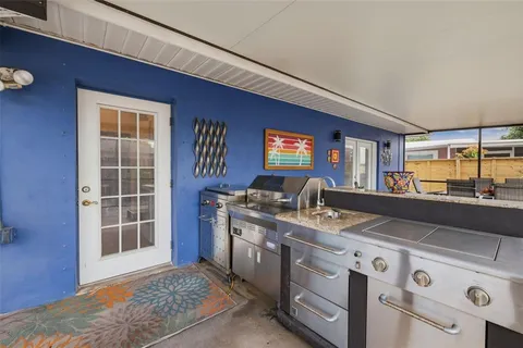 a kitchen that has a stove and a wooden floor
