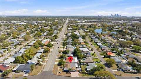 an aerial view of residential houses with city view